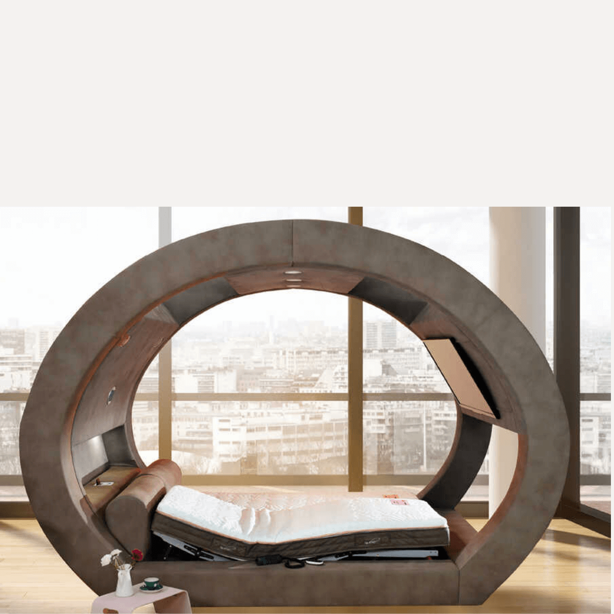 Unique circular bed design with a customizable mattress in a modern bedroom setting, overlooking a city view.