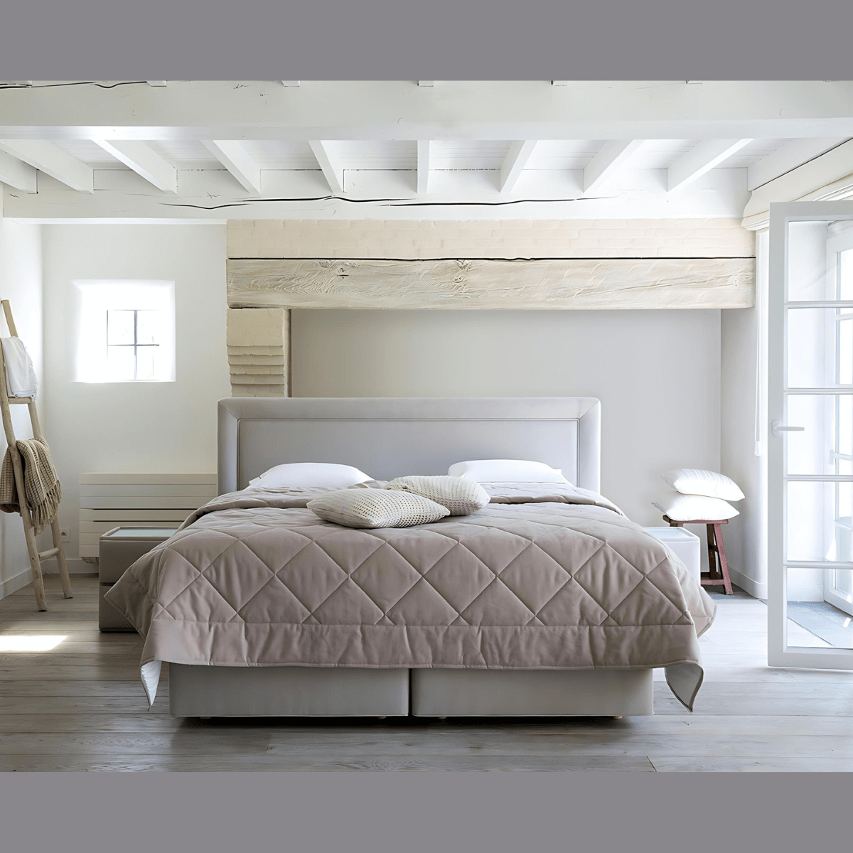 Modern customized bed with soft beige quilt in a bright, stylish bedroom interior.