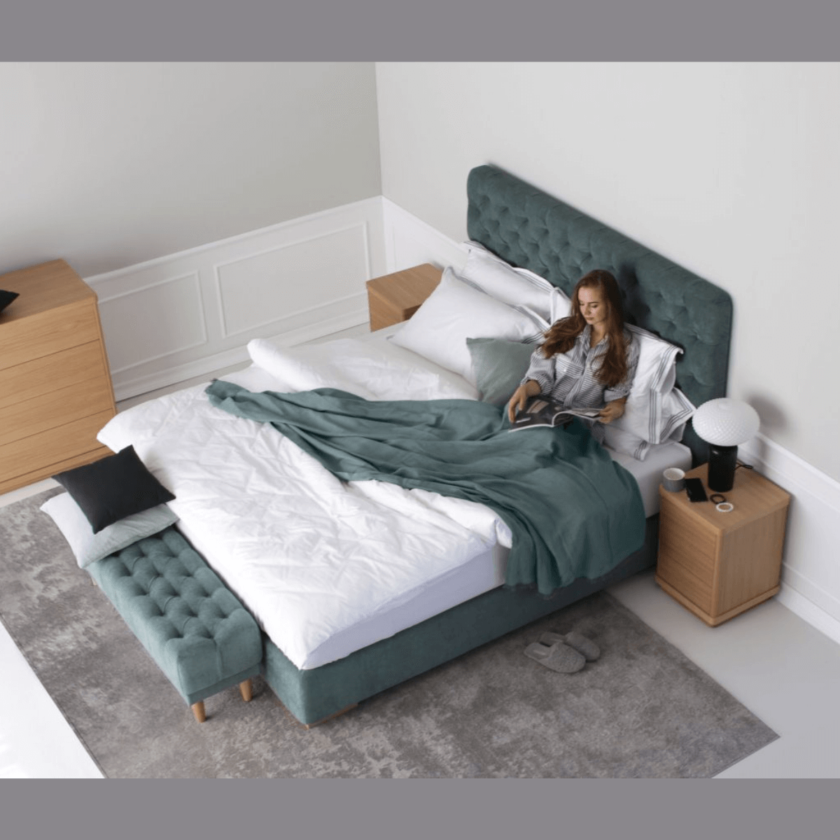 Custom bed design featuring a woman relaxing with a blanket, showcasing unique fabric and color options for personalized comfort.