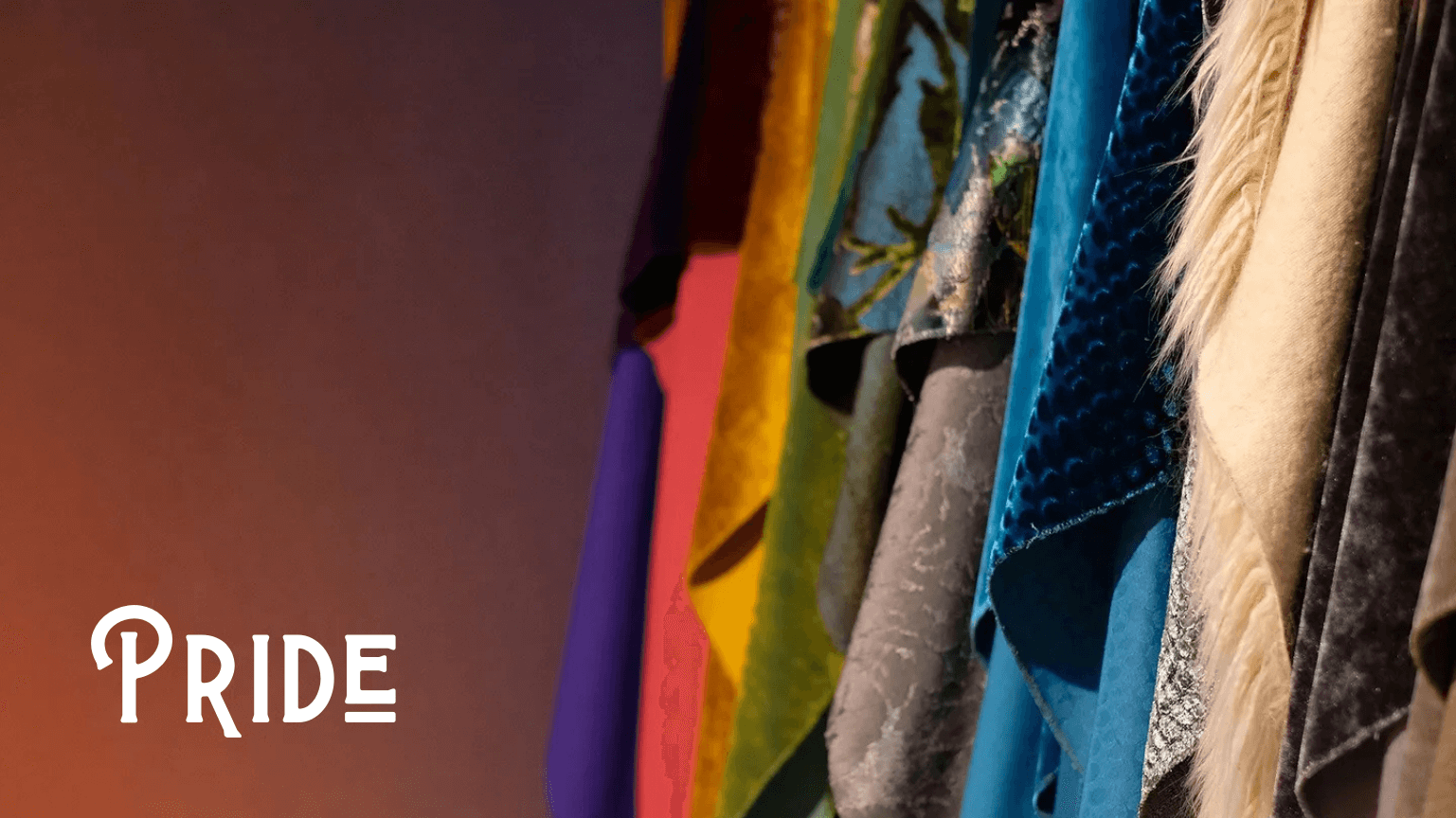 Colorful fabric swatches hanging in celebration of Pride, showcasing diversity and vibrant style.